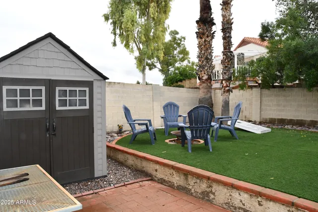 a view of a house with backyard sitting area and lake view