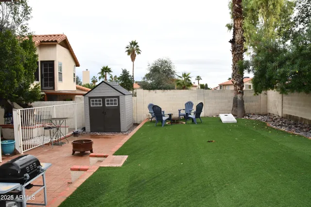 a view of a house with backyard porch and sitting area