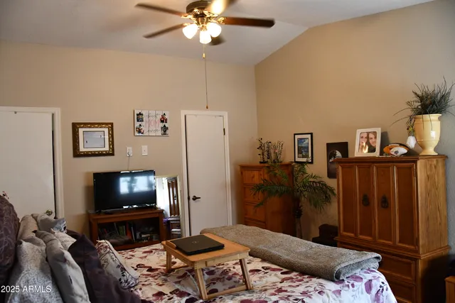 a bedroom with furniture and a flat screen tv
