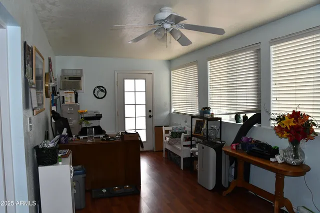 a living room with furniture a window and gym equipment