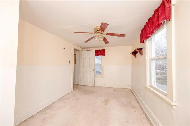 a view of a livingroom with a ceiling fan and window