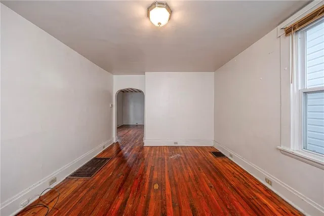 a view of a room with wooden floor and window