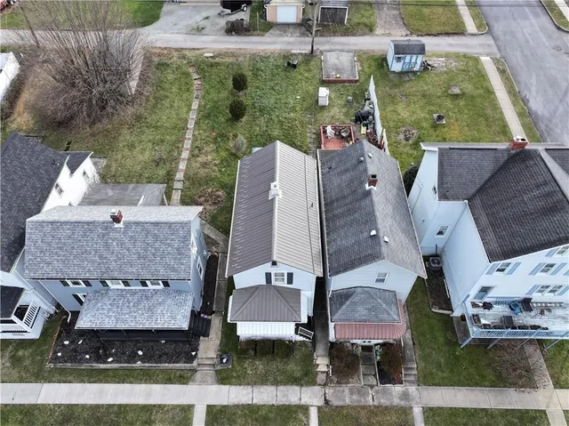 an aerial view of houses with outdoor space