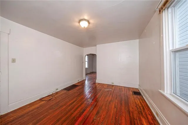 wooden floor in an empty room with a window