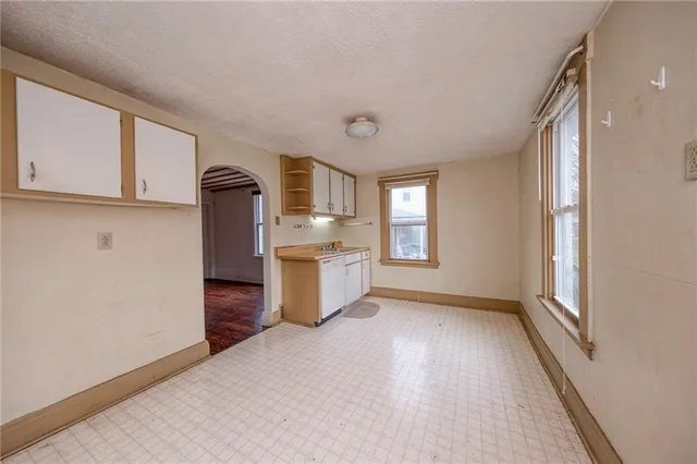 a view of a kitchen with a sink dishwasher and a refrigerator