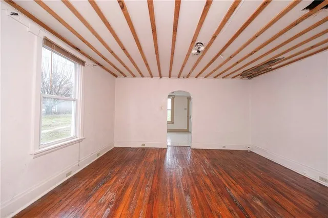wooden floor in an empty room with a window