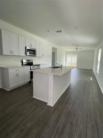 a kitchen with stainless steel appliances a refrigerator sink and cabinets