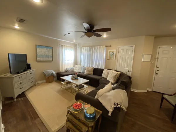 a living room with furniture and a flat screen tv