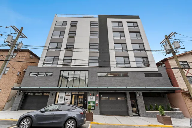 a front view of a building with parking space