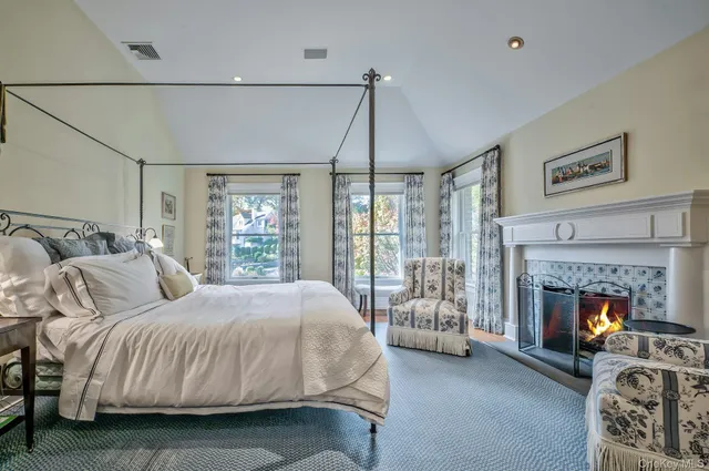 a bedroom with a bed and a fireplace