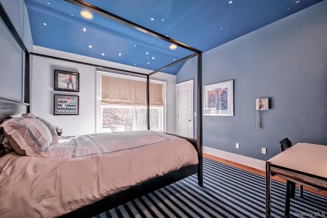 a bedroom with a large bed and a window