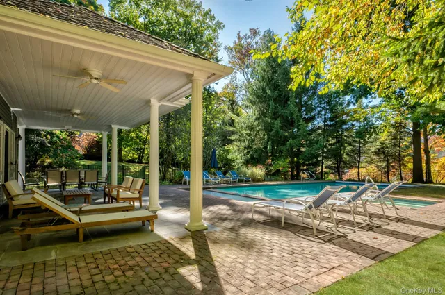 a view of a patio with swimming pool table and chairs
