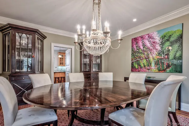 a view of a dining room with furniture wooden floor and chandelier