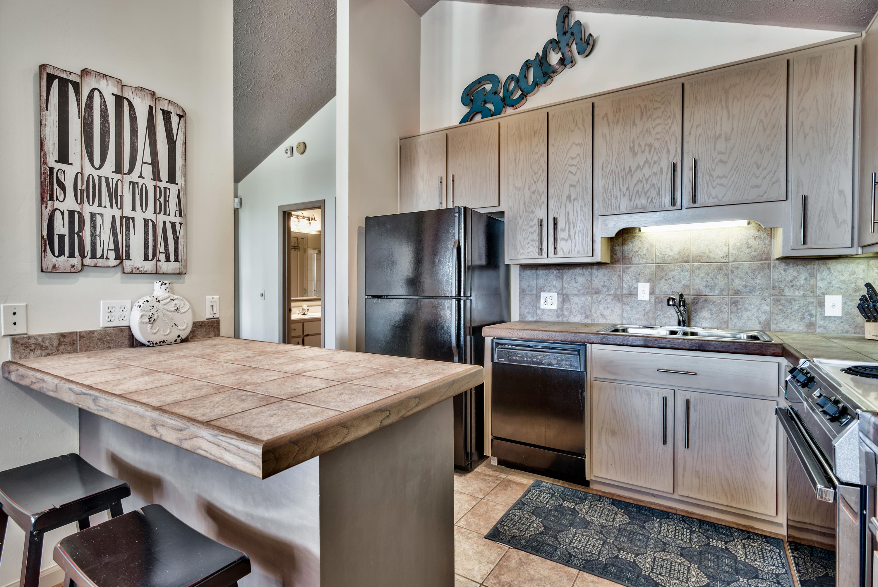 178 Pelican Circle Inlet Beach, FL 32461 - Photo 9 of 61 a kitchen with a stove a refrigerator and a sink