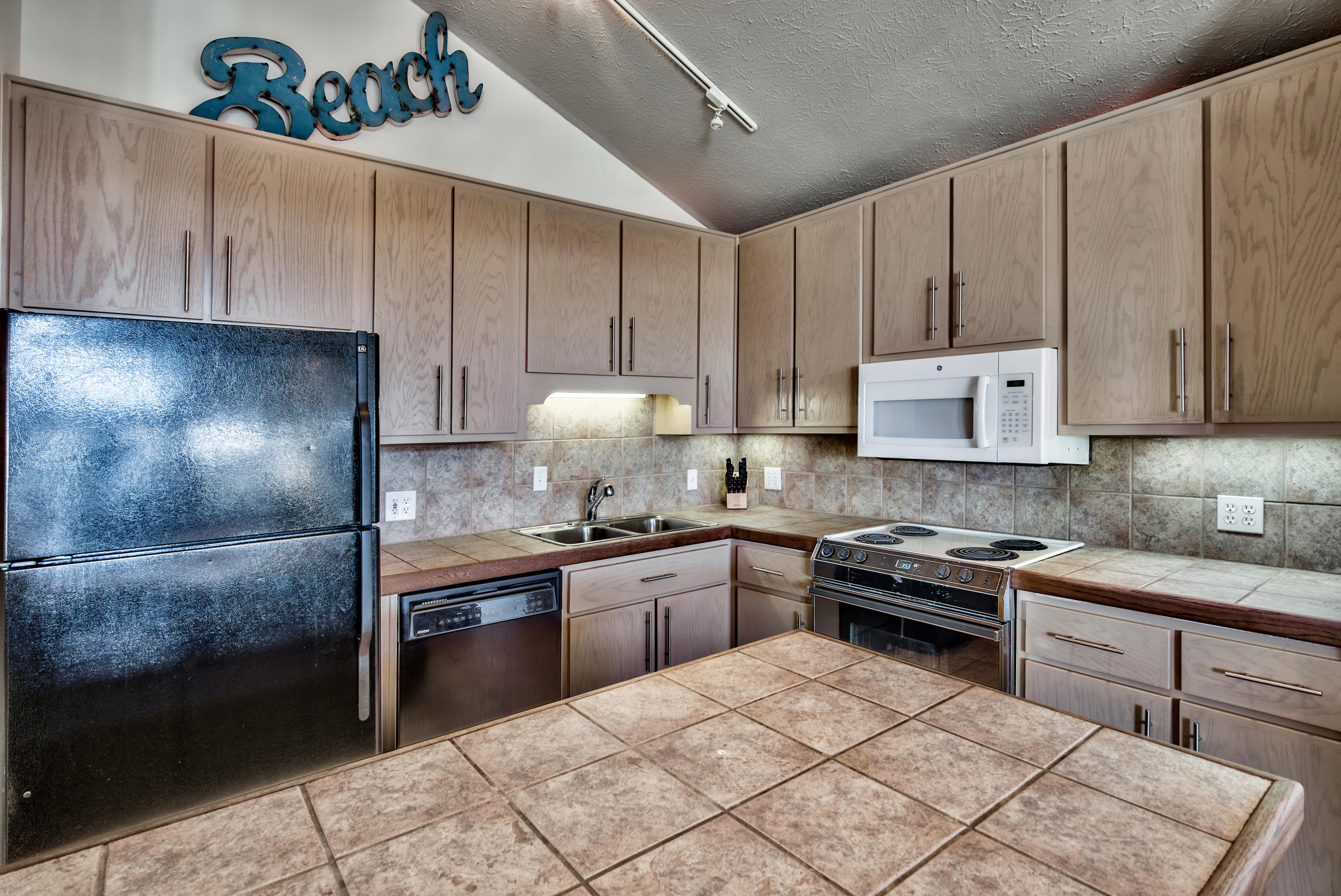 178 Pelican Circle Inlet Beach, FL 32461 - Photo 10 of 61 a kitchen with a sink a stove and cabinets