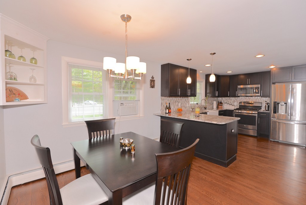 375 Hudson Road Stow, MA 01775 - Photo 5 of 30 a kitchen with a dining table chairs and refrigerator