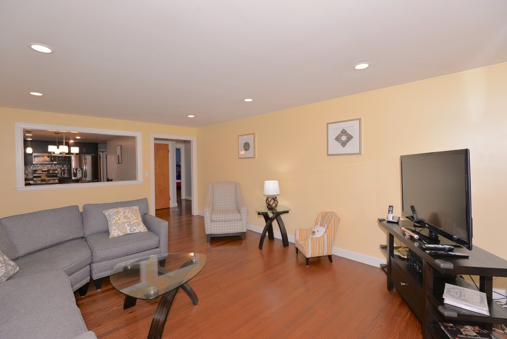 375 Hudson Road Stow, MA 01775 - Photo 8 of 30 a living room with furniture and a flat screen tv