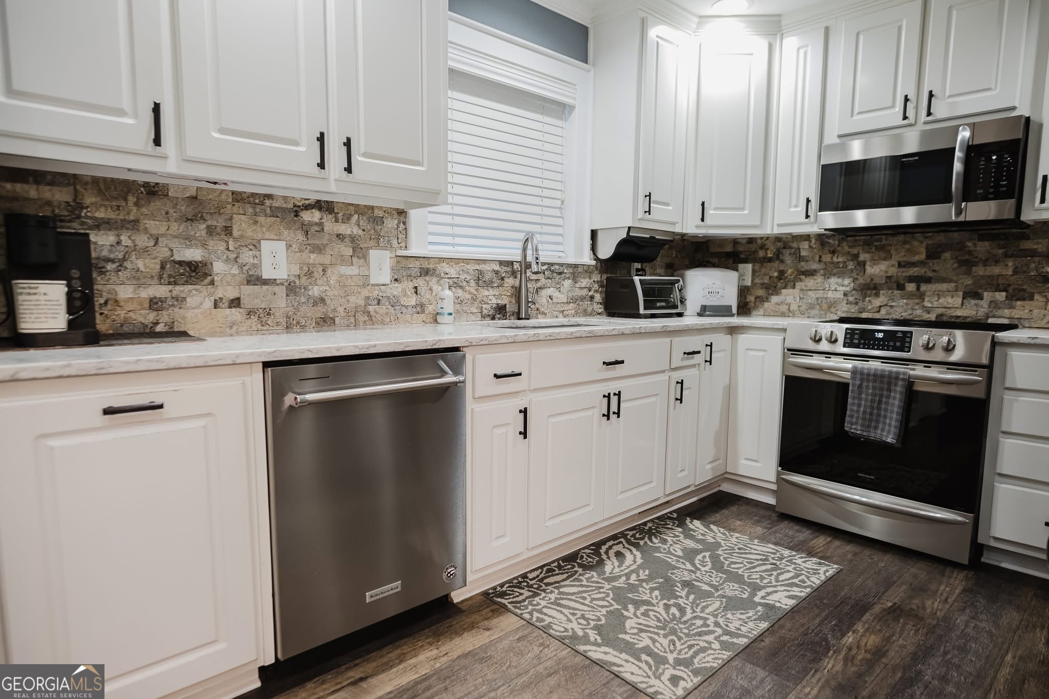 410 Country Kitchen Road Barnesville, GA 30204 - Photo 23 of 120 a kitchen with stainless steel appliances granite countertop a stove a sink and a microwave