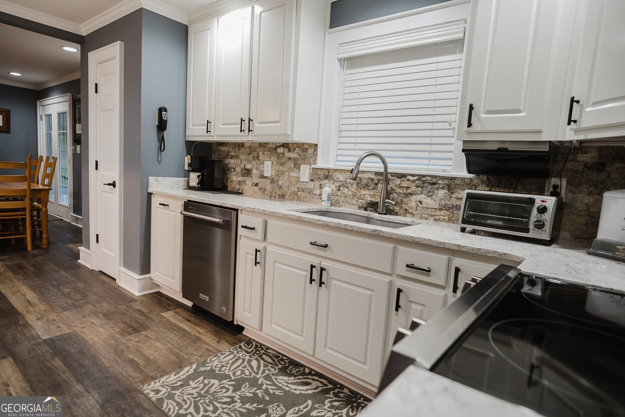 410 Country Kitchen Road Barnesville, GA 30204 - Photo 25 of 120 a kitchen with granite countertop a sink stove and cabinets
