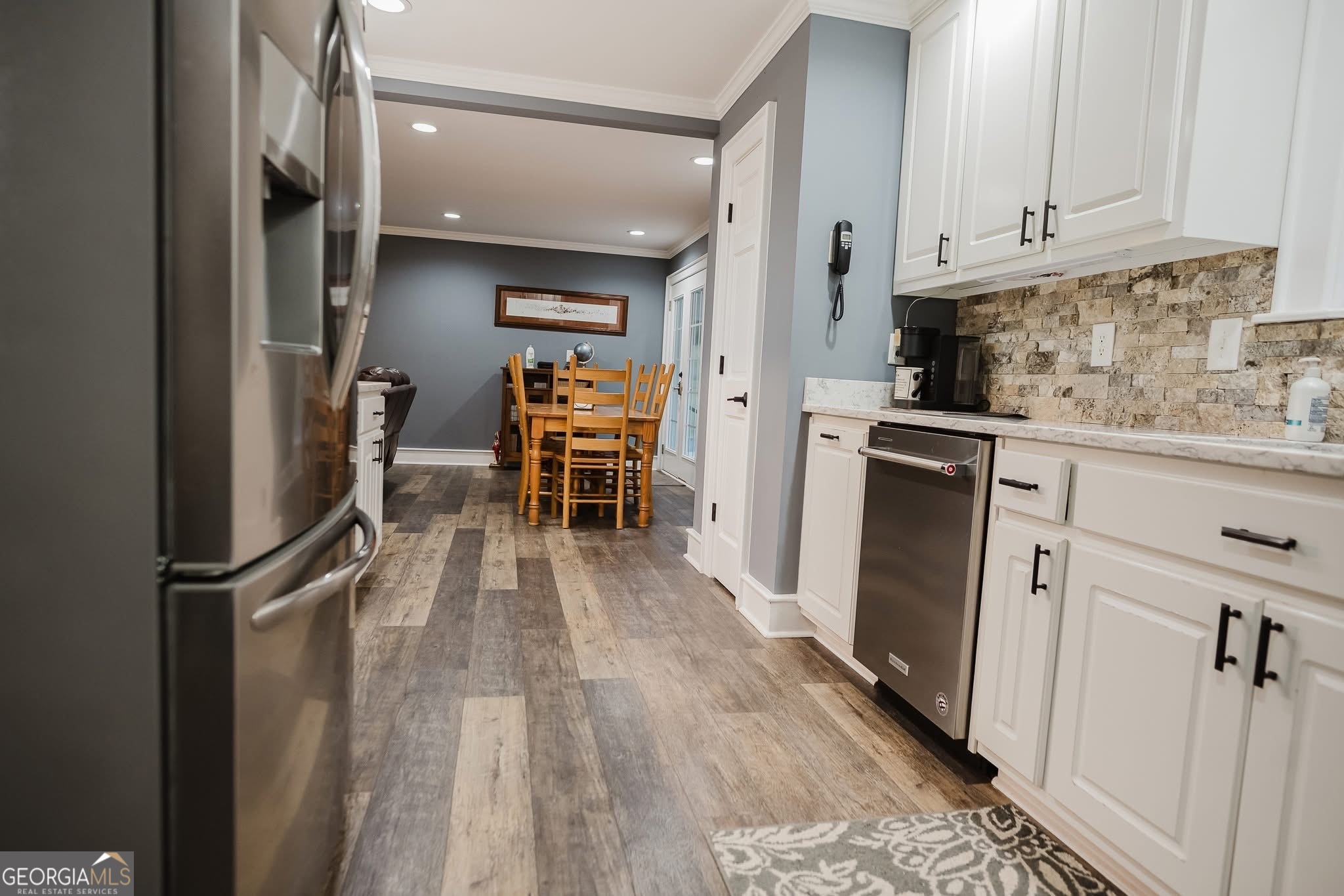 410 Country Kitchen Road Barnesville, GA 30204 - Photo 27 of 120 a kitchen with granite countertop a refrigerator stove and white cabinets