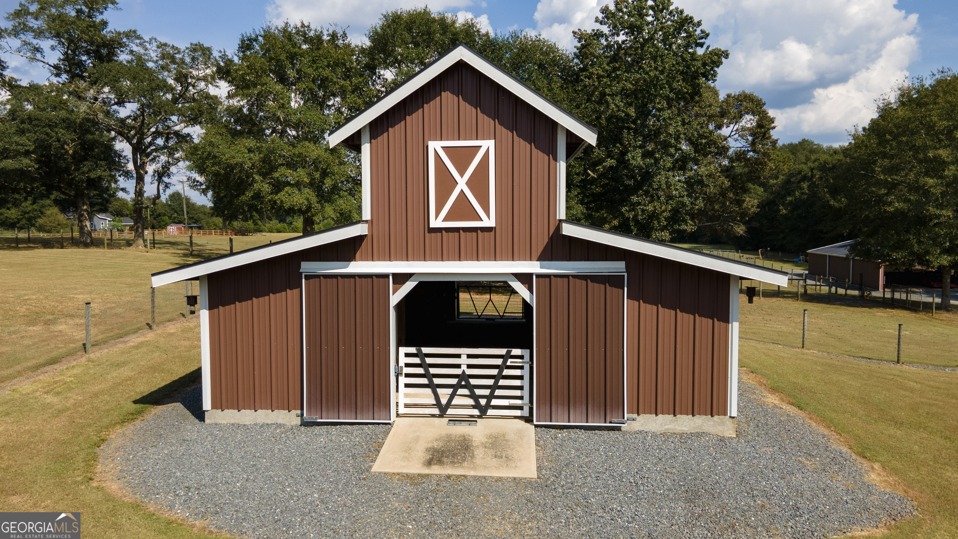 410 Country Kitchen Road Barnesville, GA 30204 - Photo 64 of 120 a view of a house with a garage and balcony