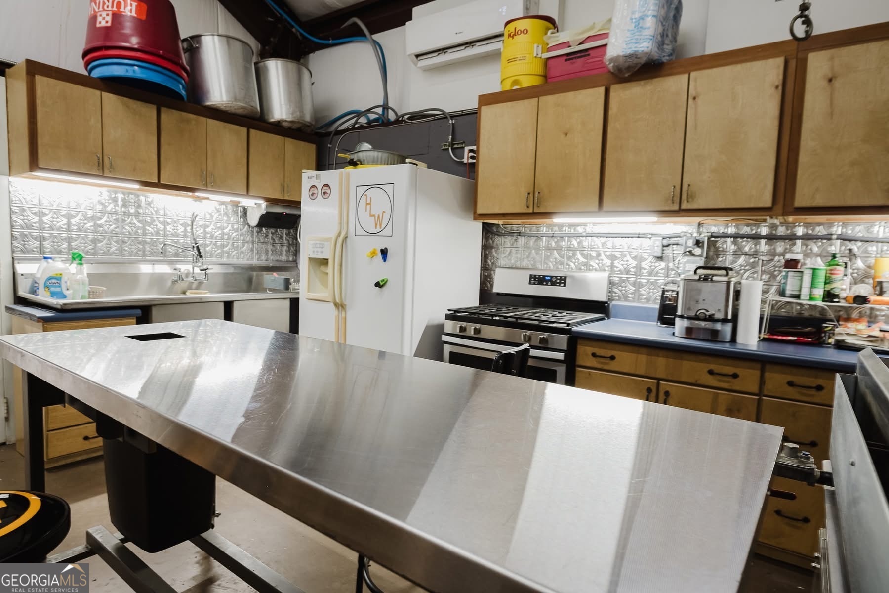 410 Country Kitchen Road Barnesville, GA 30204 - Photo 86 of 120 a kitchen with stainless steel appliances a stove a sink and a refrigerator