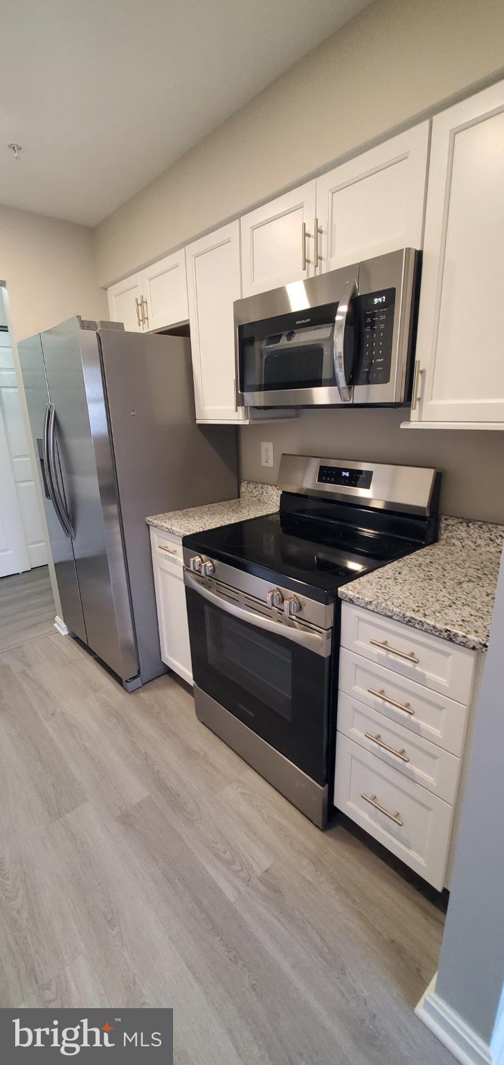 8343 Montgomery Run Road Ellicott City, MD 21043 - Photo 15 of 36 Sleek modern kitchen with stainless appliances.