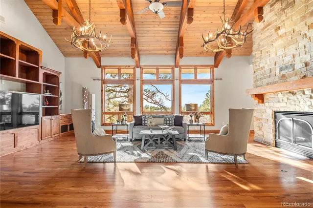 a dining room with stainless steel appliances granite countertop a dining table chairs and a refrigerator