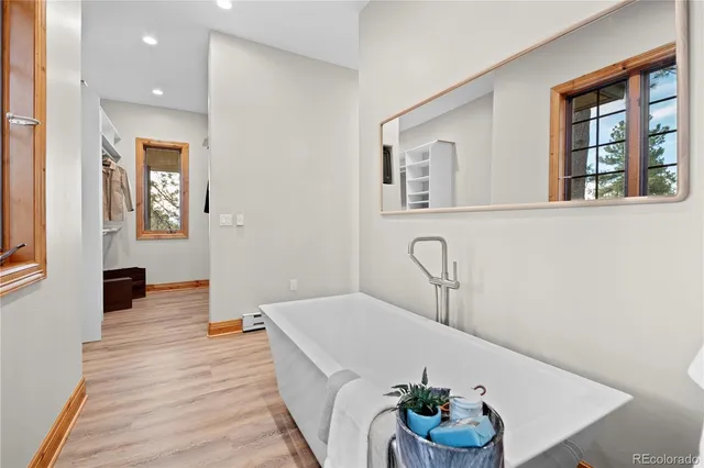 a bathroom with a double vanity sink mirror and toilet