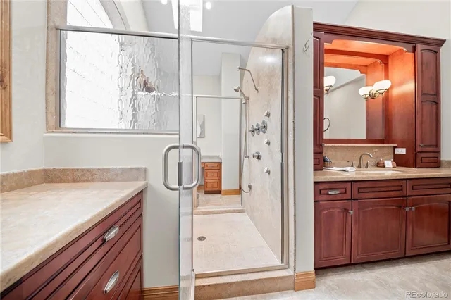 a bedroom with a large bed a chandelier and closet