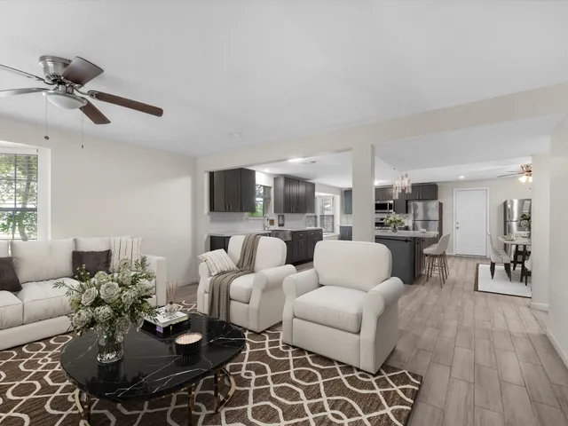 a living room with furniture and a wooden floor
