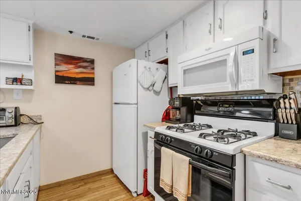 a dining table chairs and a stove