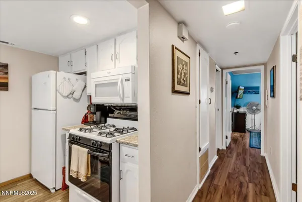 a bedroom with a bed a flat screen tv and a window