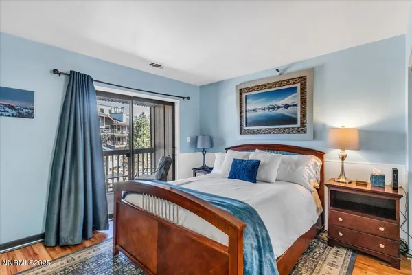 a bedroom with a bed and a view of kitchen