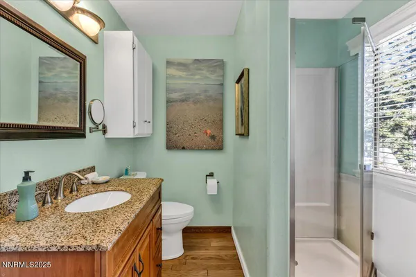 a bedroom with a bed and a painting on the wall