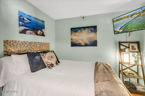 a bedroom with a bed and a flat screen tv