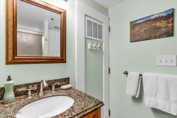 a white toilet sitting next to a bathroom sink