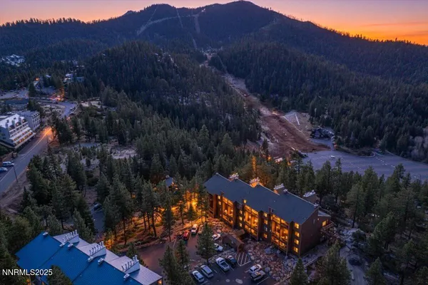 a view of a lush green hillside and a houses