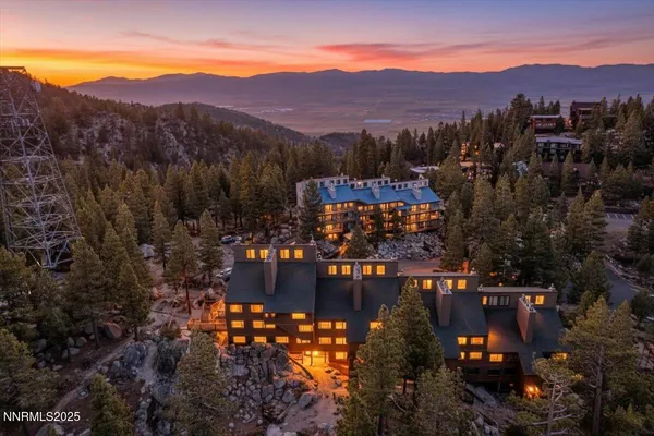 a view of a lush green hillside and houses