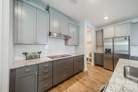 a kitchen with a sink stainless steel appliances and cabinets