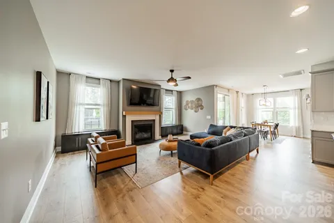 a living room with furniture flat screen tv and a fireplace