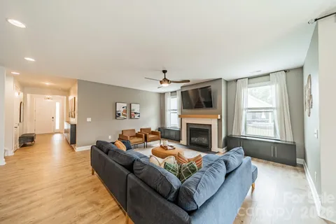 a living room with furniture a fireplace and a flat screen tv