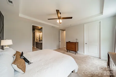 a bedroom with a bed and a television