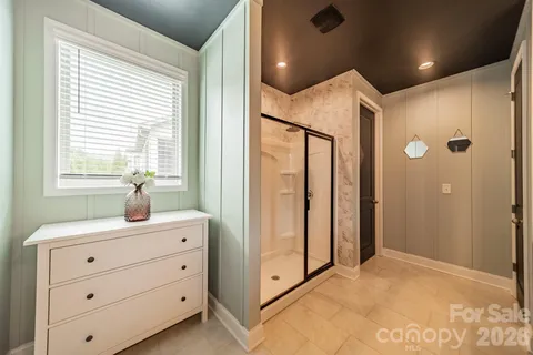 a view of hallway with window and cabinet