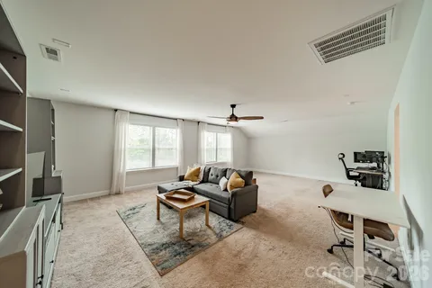 a living room with furniture a window and a table