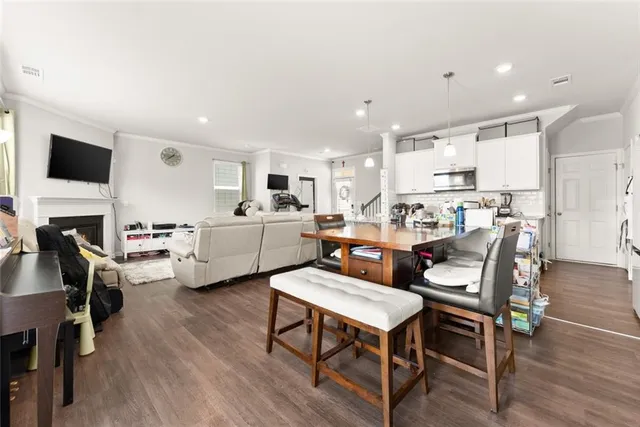 a living room with furniture kitchen view and a fireplace