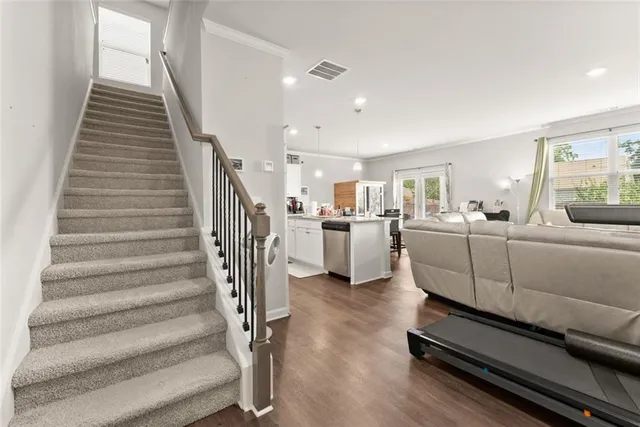 a living room with furniture and stairs
