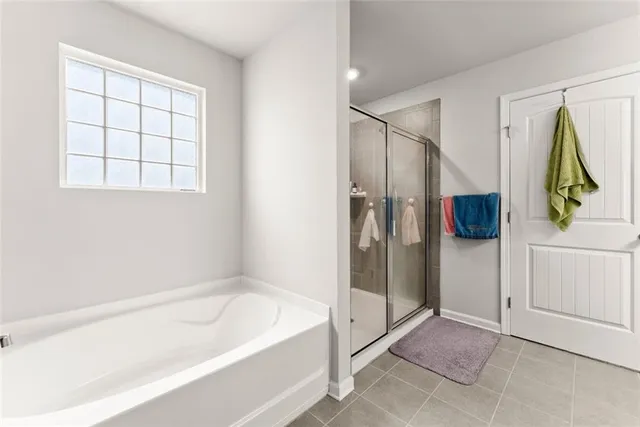 a bathroom with a tub and a shower