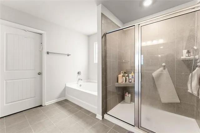 a bathroom with a bathtub and a shower