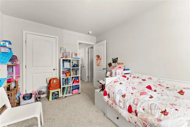 a living room with lots of baby furniture and toys